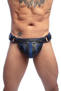 Front-on shot of male model in an original ARMY OF MEN black and blue leather thong with matte black metal hardware.