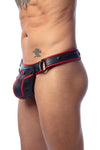 A toned model in three-quarter pose wearing a handcrafted ARMY OF MEN COMBAT THONG - Red with matte black O-rings.