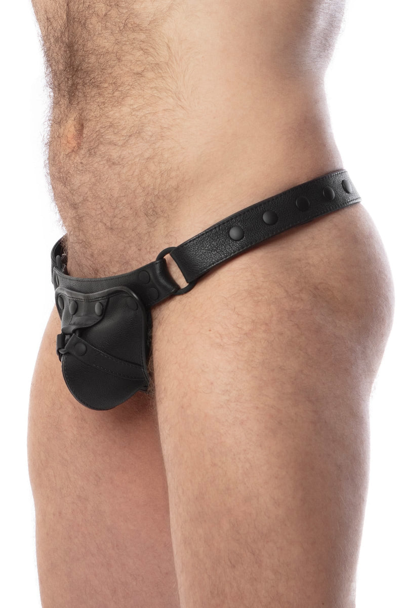 Model wearing a black leather thong with a black harness codpiece. Matt black hardware. Side view.