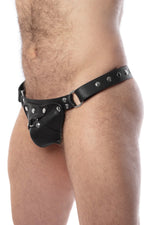 Model wearing a black leather thong with stainless steel hardware and a matching harness codpiece. Side view.