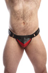 Model wearing a black leather thong with a red shadow codpiece. Matt black hardware. Front view.
