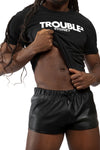 Male model facing forward in a black organic cotton ARMY OF MEN "TROUBLE" slim-fit t-shirt, showing off his abs.