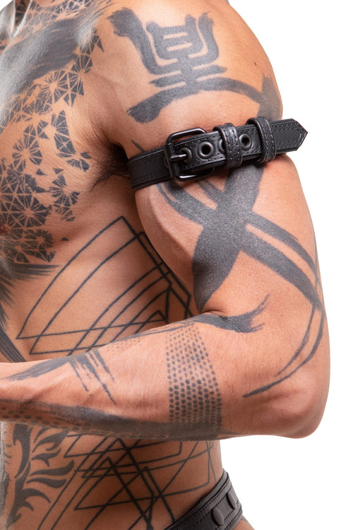 Model wearing a 1" black leather combat armband belt with matt black hardware