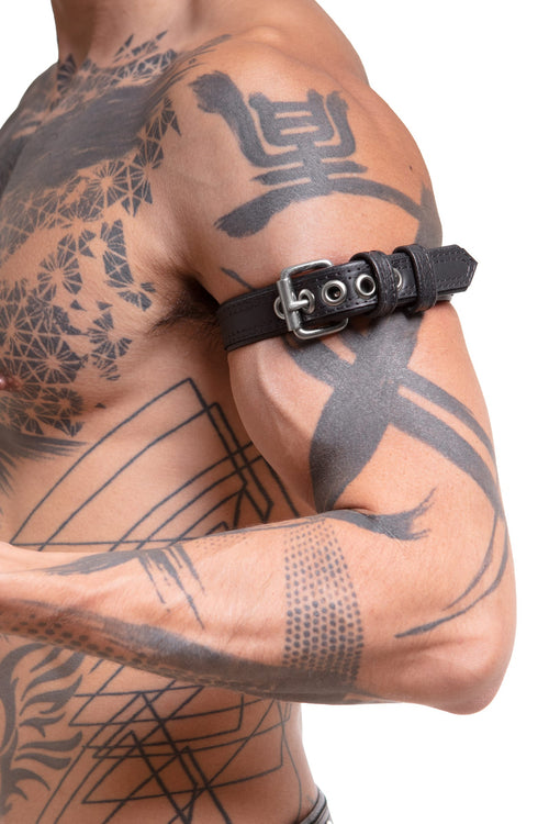 Model wearing a 1" black leather combat armband belt with stainless steel hardware