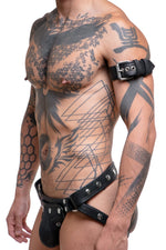 Model wearing a 1.5" black leather combat armband belt with stainless steel hardware