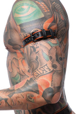 Model wearing a narrow 1" black and orange leather armband belt