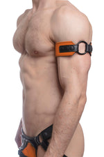 Model wearing an orange leather armband with black metal O-ring