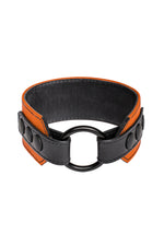 An orange leather armband with black metal O-ring