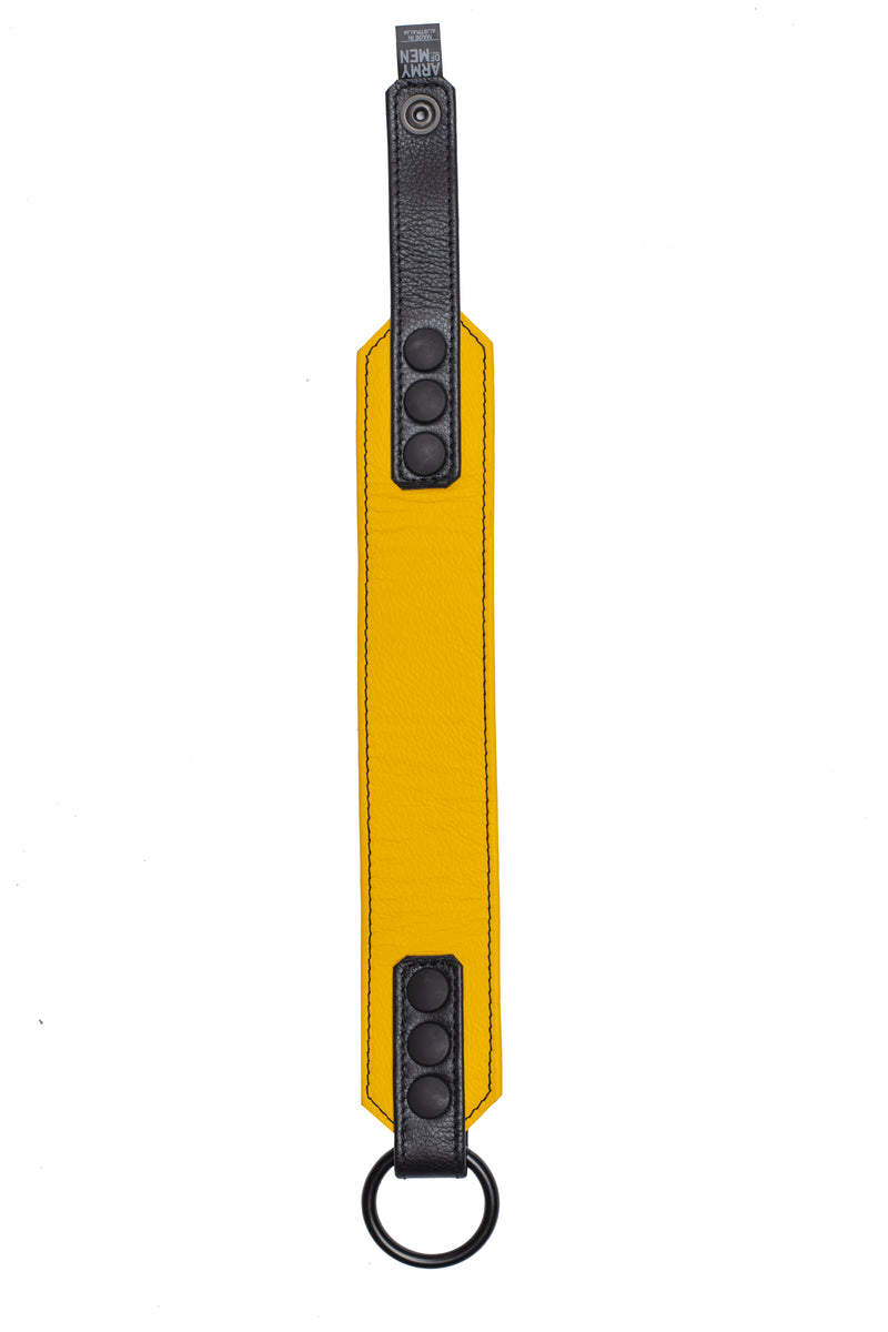 A yellow leather armband with black metal O-ring