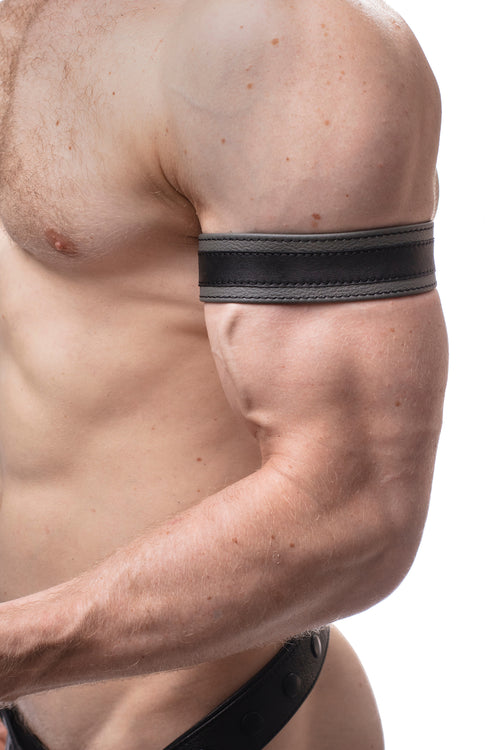 Model wearing a 1.5" grey leather armband with black racing stripe detail.