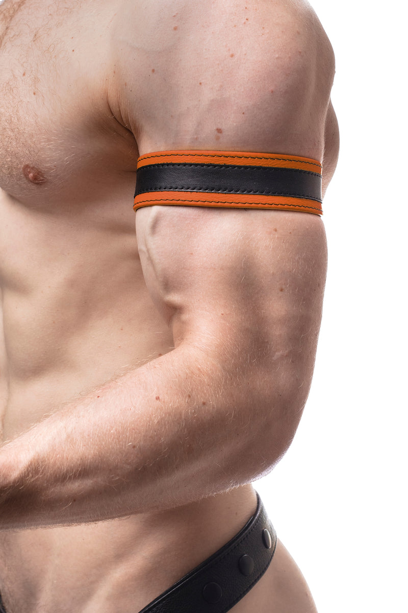 Model wearing a 1.5" orange leather armband with black racing stripe detail