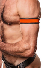 Model wearing a 1.5" wide black leather armband with fluro orange leather racer stripe