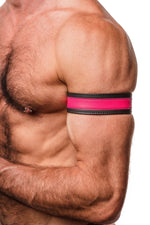 Model wearing a 1.5" wide black leather armband with fluro pink leather racer stripe