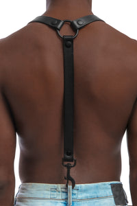 Model wearing black leather braces with black metal hardware attached to jeans. Back 1.