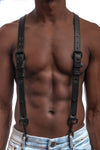 Model wearing black leather braces with black metal hardware attached to jeans. Front 1.