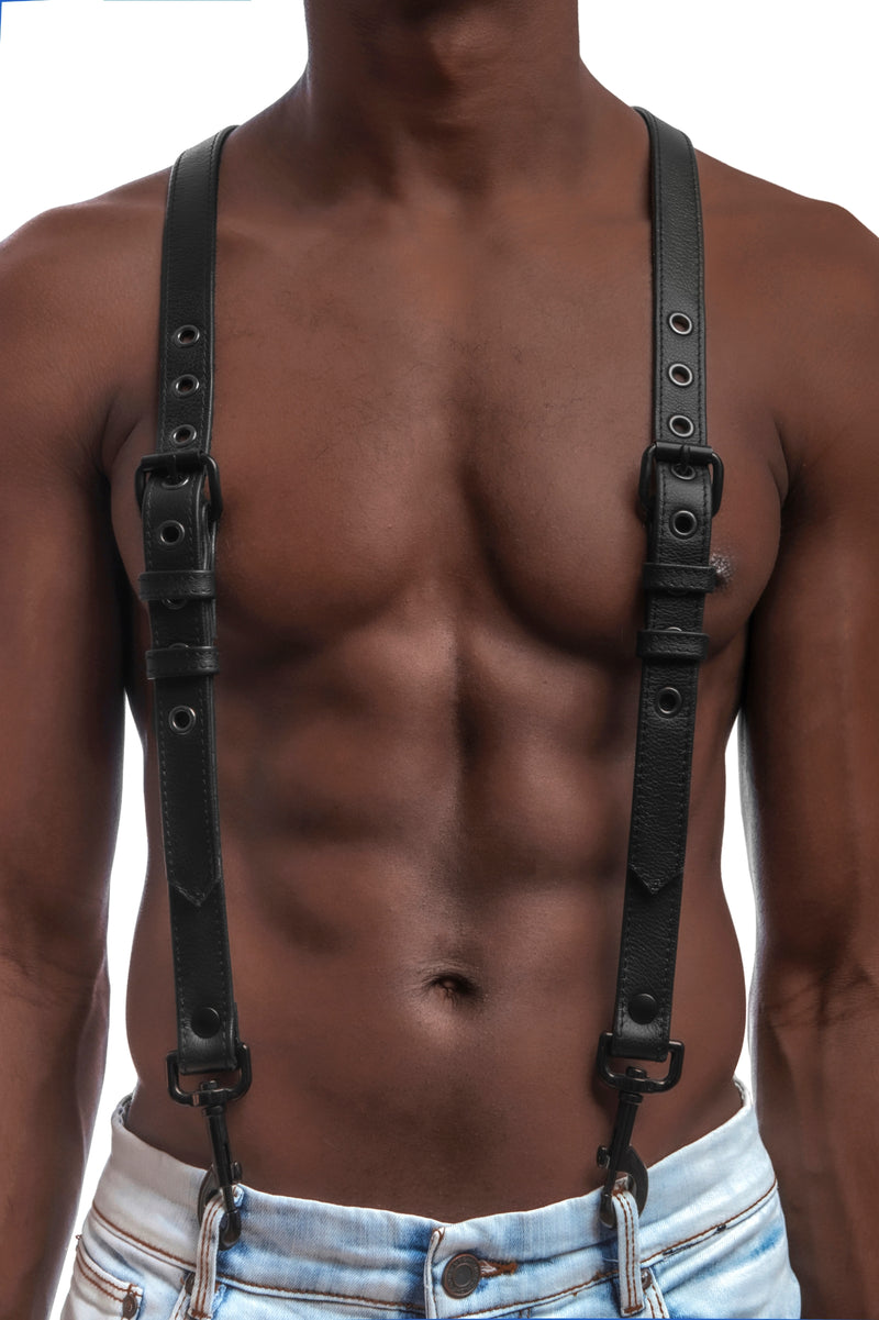 Model wearing black leather braces with black metal hardware attached to jeans. Front 1.