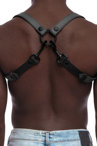 Model wearing grey and black leather braces with black metal hardware attached to jeans. Back view.