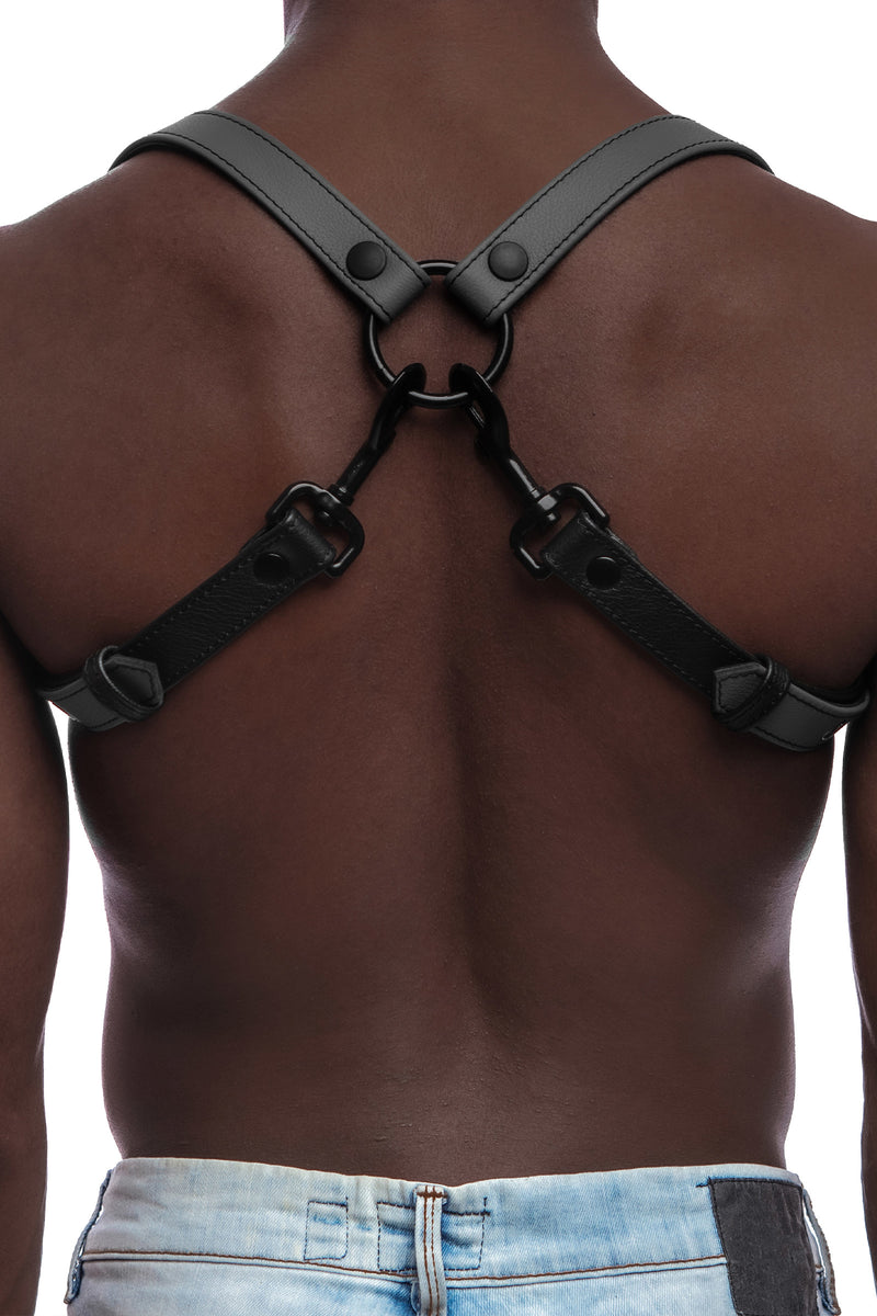 Model wearing grey and black leather braces with black metal hardware attached to jeans. Back view.