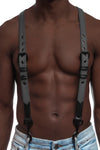 Model wearing grey and black leather braces with black metal hardware attached to jeans. Front view.