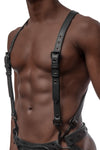 Model wearing black leather braces kit with black metal hardware attached to jockstrap. Front.