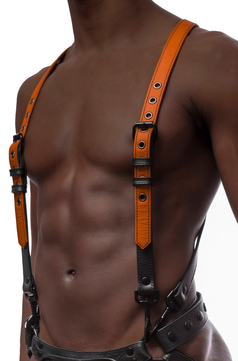 Model wearing orange and black leather braces kit with black metal hardware attached to leather jock. Front view.