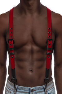 Model wearing red and black leather braces with black metal hardware attached to jeans. Front view.