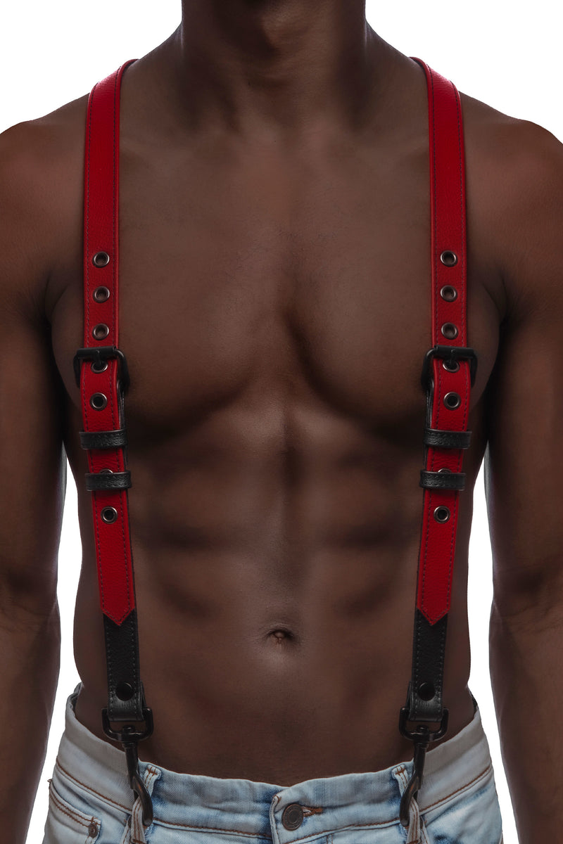 Model wearing red and black leather braces with black metal hardware attached to jeans. Front view.