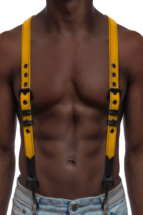 Model wearing yellow and black leather braces with black metal hardware attached to jeans.