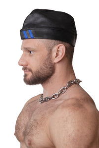 Model wearing black flight cap with blue stripes