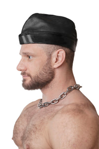 Model wearing black flight cap with grey stripes
