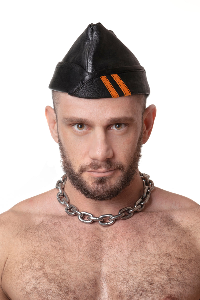 Model wearing black flight cap with orange stripes