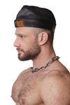 Model wearing black flight cap with orange stripes