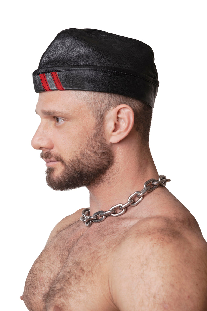 Model wearing black flight cap with red stripes