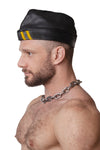 Model wearing black flight cap with yellow stripes