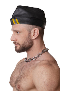 Model wearing black flight cap with yellow stripes