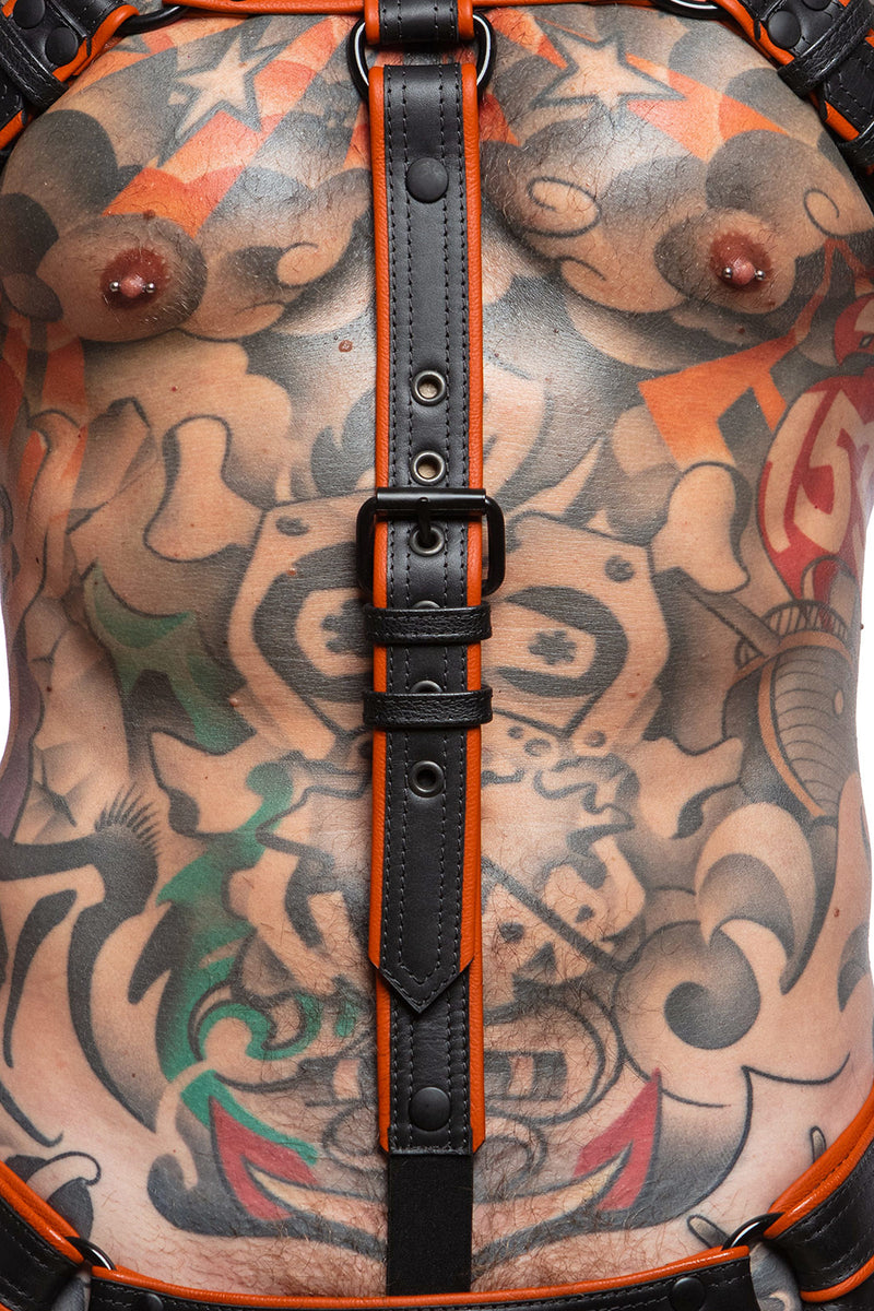 Model wearing a black and orange combat cockstrap. Close up view.