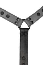 Grey leather bulldog harness connector with black hardware. Close up.