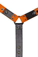 Orange leather bulldog harness connector with black hardware. Lining.