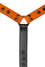 Orange leather bulldog harness connector with black hardware. Close up.