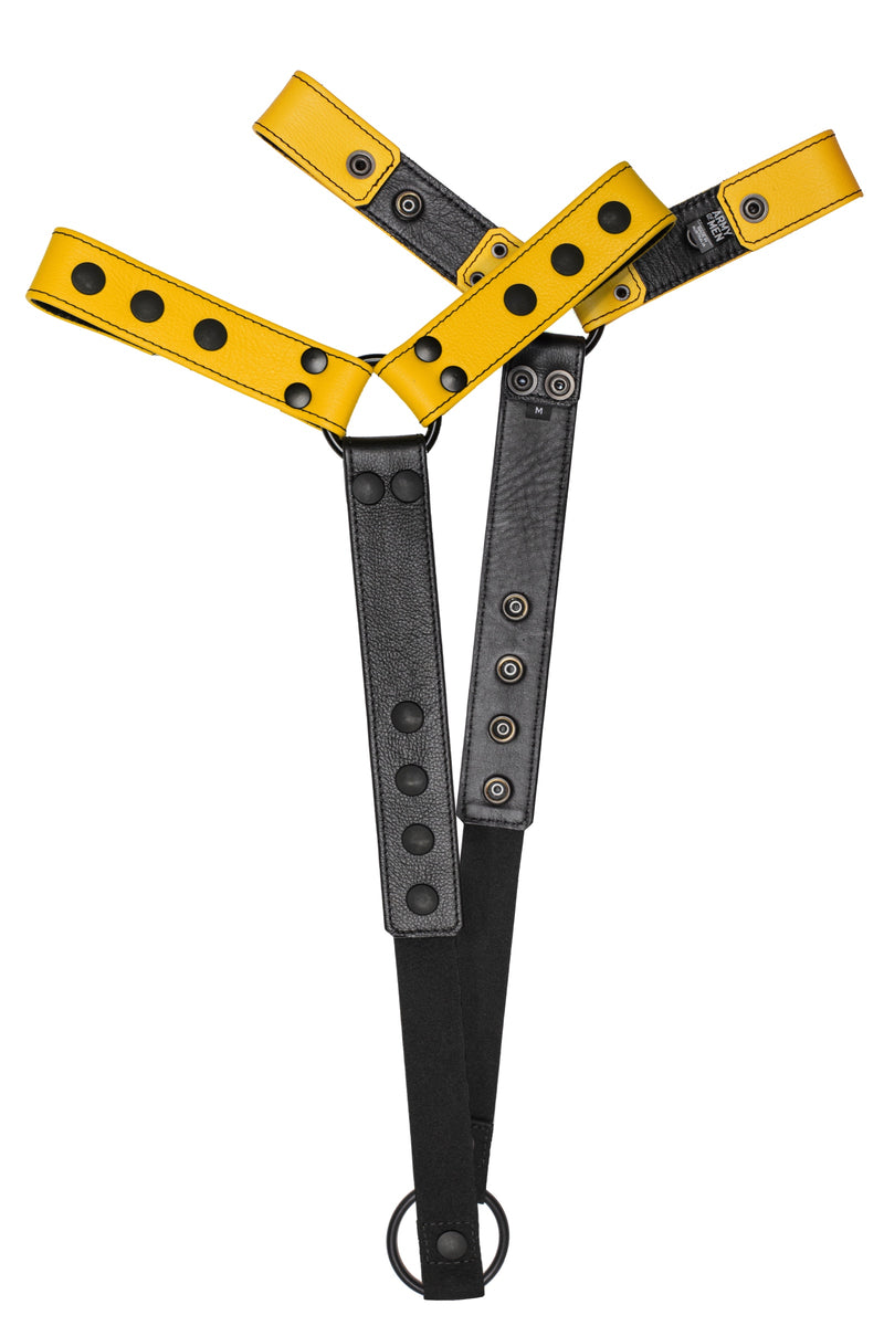 Pair of yellow leather bulldog harness connectors with black hardware.