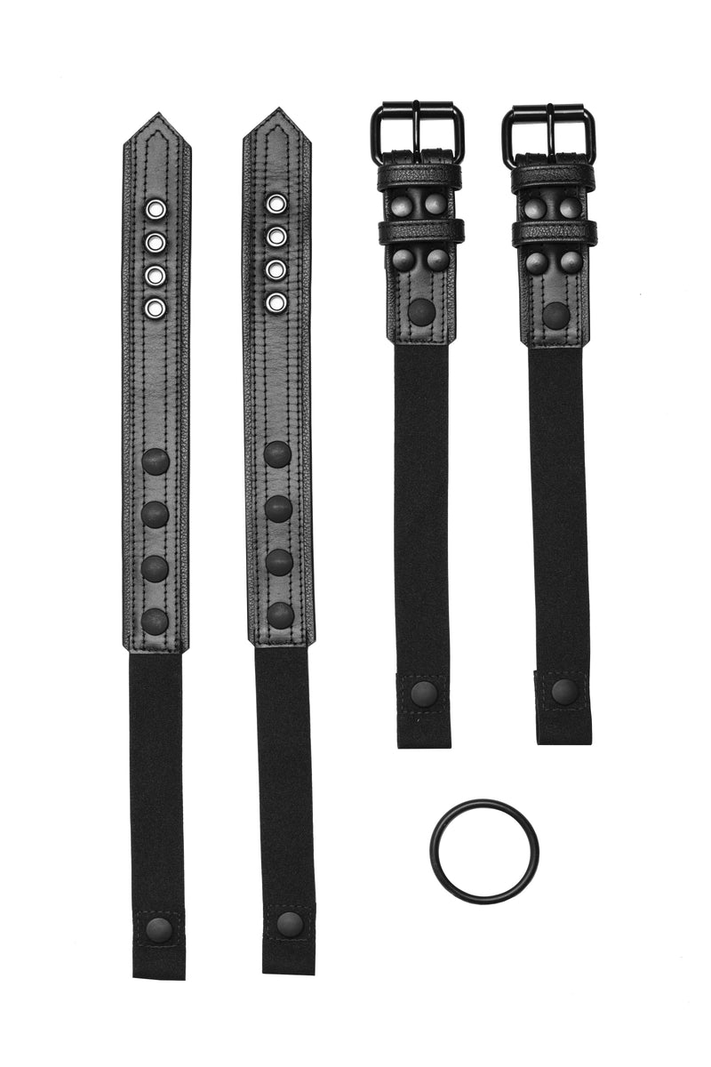 Pair of black leather combat harness connectors with black hardware. Front.