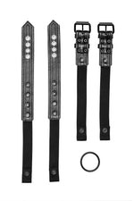 Pair of black leather combat harness connectors with black hardware. Back.