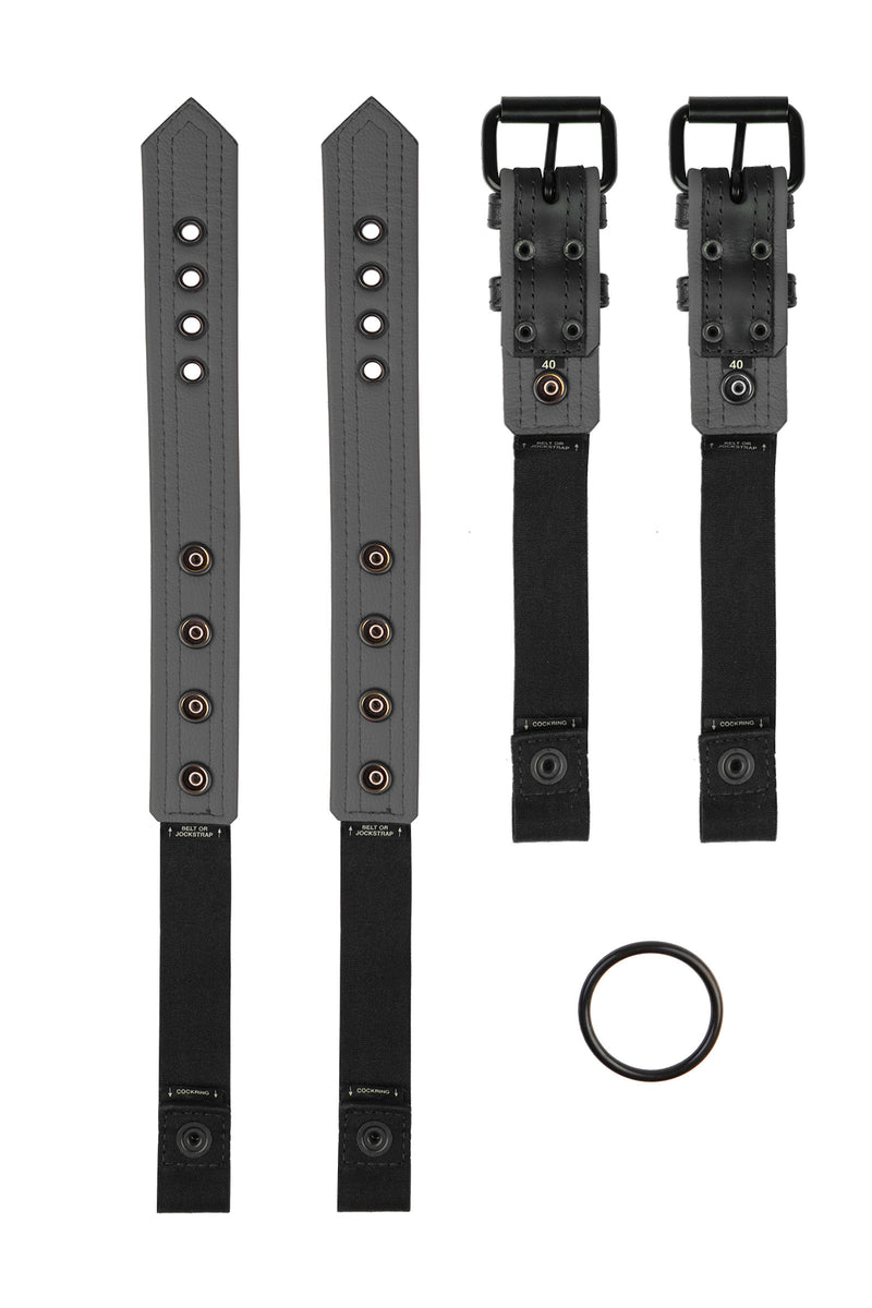 Pair of black and grey leather combat harness connectors with black hardware. Separated. Back view.