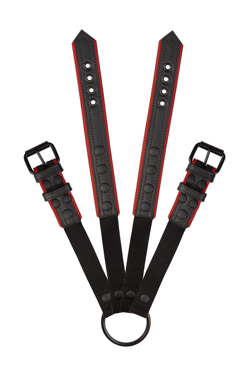 Pair of black and red leather combat harness connectors with black hardware. Connected. Front view.