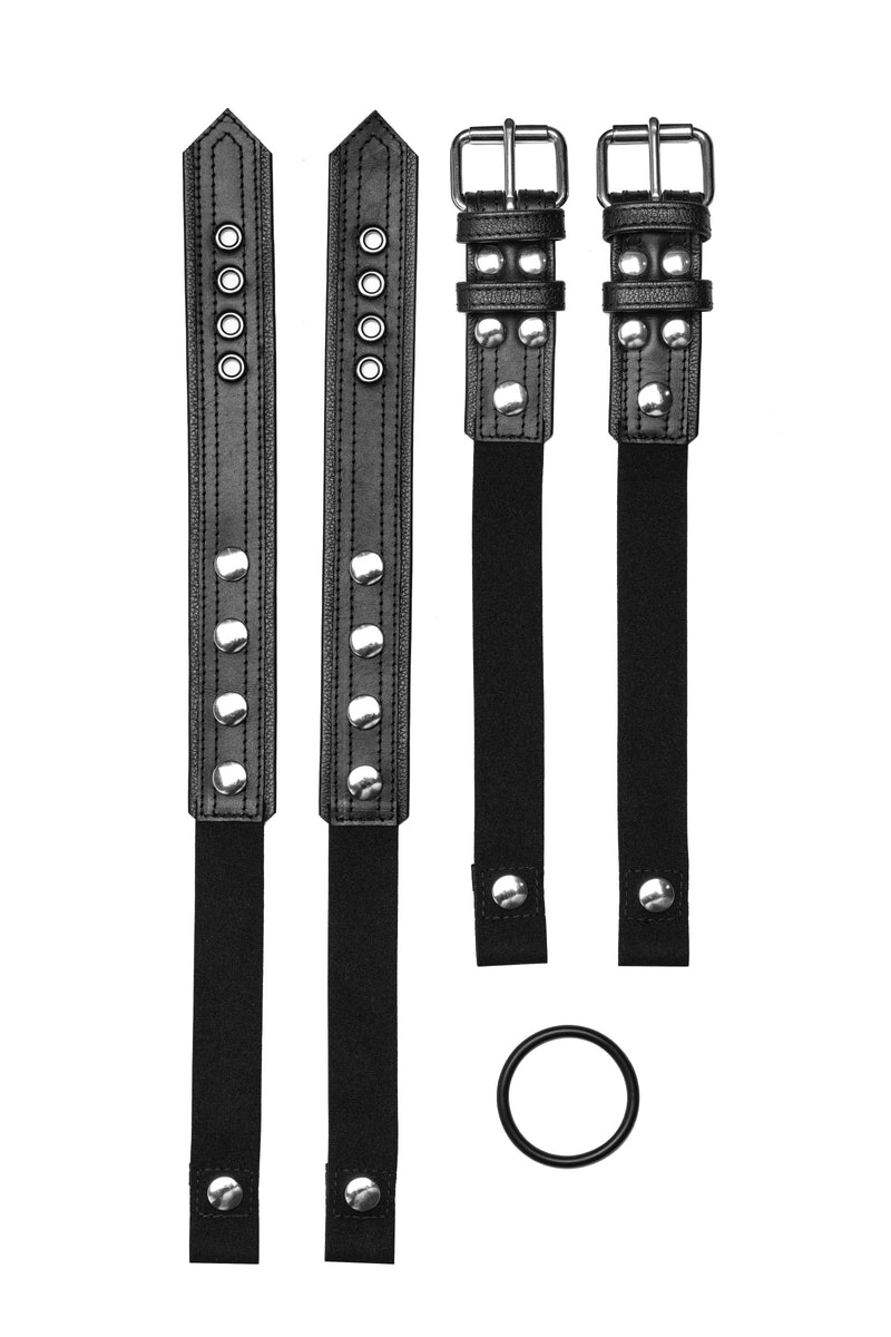 Pair of black leather combat harness connectors with stainless steel hardware. Front view.