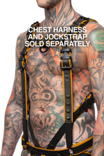 Chest harness sold separately. Model wearing a black and yellow leather combat harness and connector with black metal hardware. Side view.