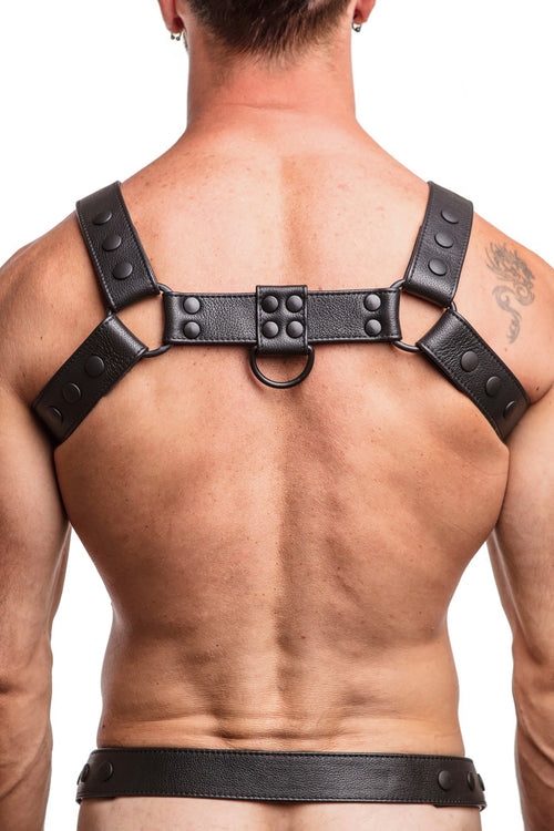 Model wearing black leather bulldog harness with black hardware. Back.