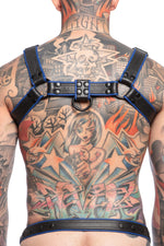 Model wearing black and blue leather combat bulldog harness with matt black metal hardware. Back view.