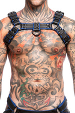 Model wearing black and blue leather combat bulldog harness with matt black metal hardware. Front view.
