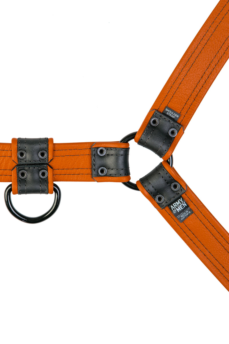Black and orange leather combat bulldog harness with matt black metal hardware. Back view.
